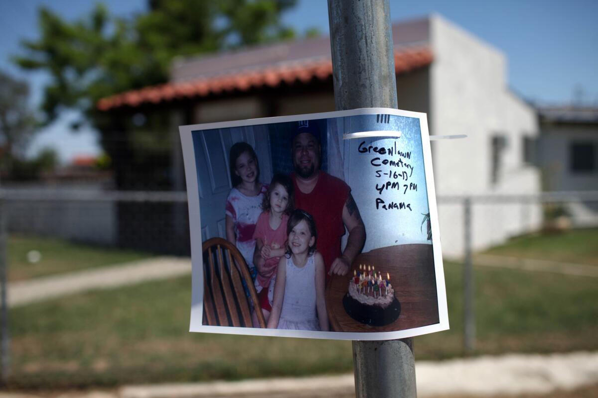 A photograph of David Sal Silva and some of his children posted on a pole near where his fatal encounter with Kern County deputies occurred in East Bakersfield in 2013.