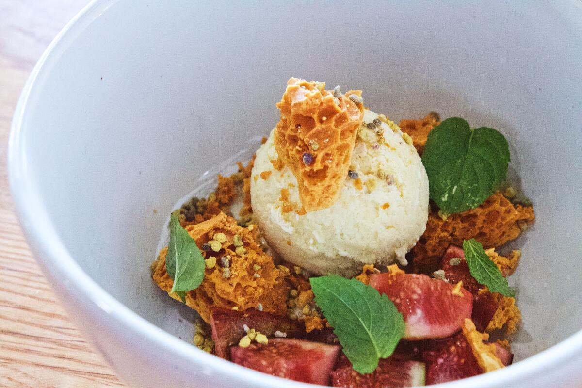 A bowl of fig leaf ice cream with honeycomb crisp, figs and mint from Long Beach restaurant Heritage