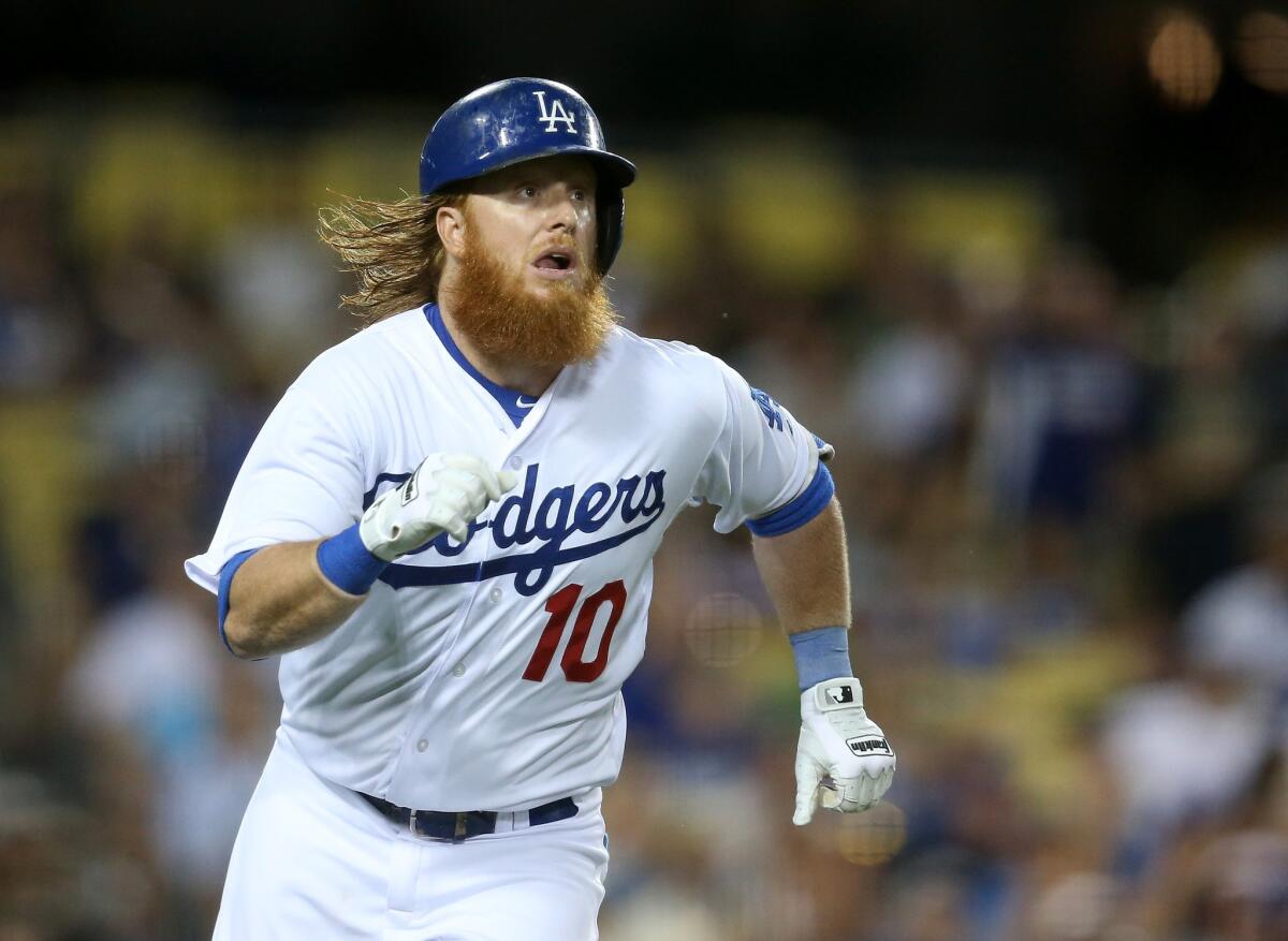 Dodgers third baseman Justin Turner runs to first on a single during a game against the Cincinatti Reds on August 13.
