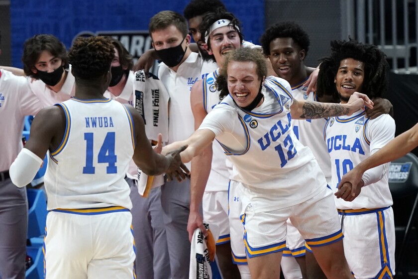 UCLA's Mac Etienne, right, celebrates with Kenneth Nwuba in the final moments of the Bruins' win over Abilene Christian.