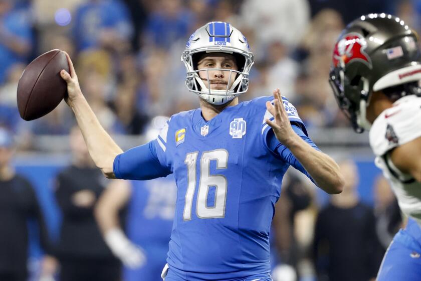 Detroit Lions quarterback Jared Goff (16) passes for a touchdown in the first half.