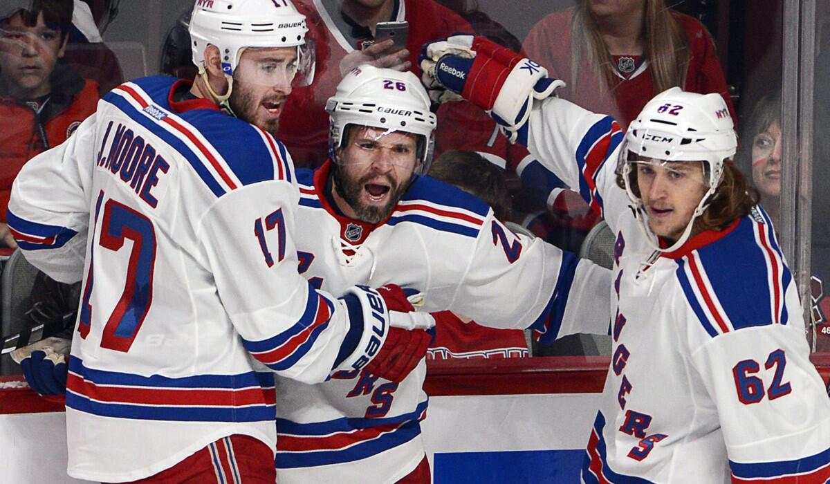 Rangers right wing Martin St. Louis (26) celebrates with teammates John Moore and Carl Hagelin after scoring against the Canadiens in the first period of Game 1 on Saturday in Montreal.