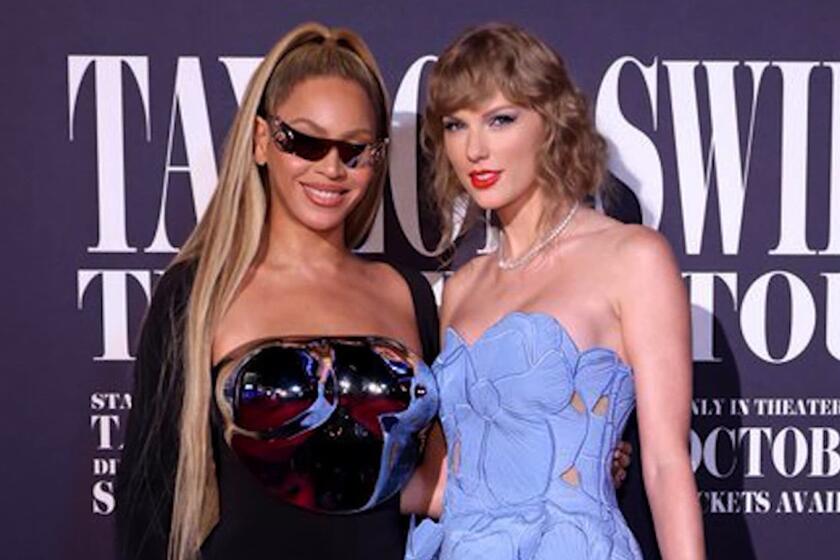 Beyonce poses with Taylor Swift at the "Eras" film premiere in Los Angeles