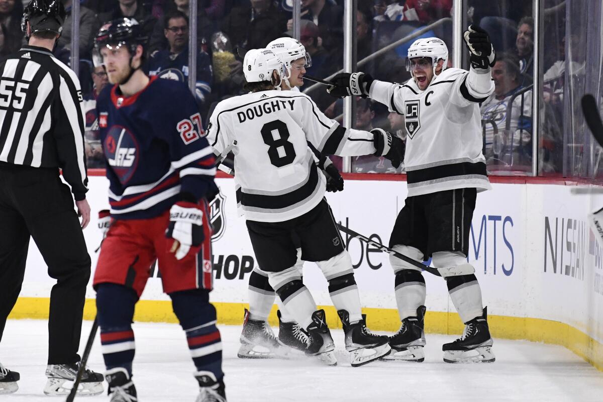 The Kings' Anze Kopitar celebrates his goal against the Jets with Drew Doughty in Winnipeg, Manitoba, on Tuesday.