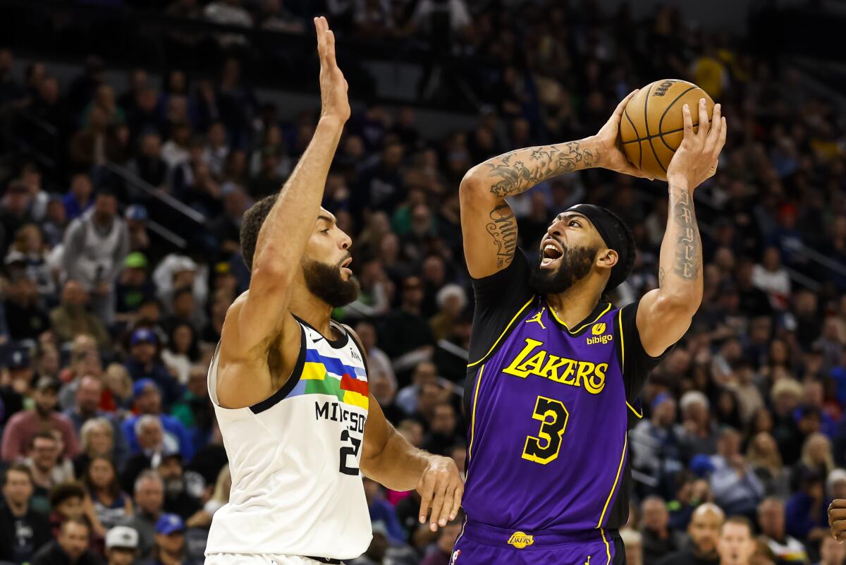 Timberwolves center Rudy Gobert defends Lakers forward Anthony Davis as he attempts a shot.