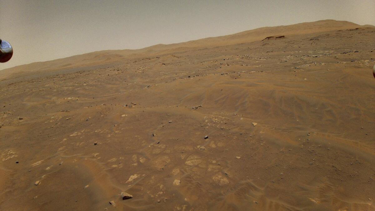 This May 22, 2021 photo made available by NASA shows the surface of Mars from a height of 33 feet (10 meters), captured by the Ingenuity Mars helicopter during its sixth flight. (NASA/JPL-Caltech via AP)