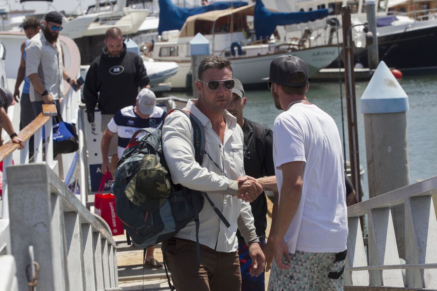SAN DIECongressman Duncan D. Hunter, left, who was indicted yesterday on campaign finance violations says he is going to fight Òpolitically motivatedÓ charges against him after returning from a Rivers of Recovery Fishing Tournament for Wounded Combat Veterans fundraiser in San Diego. He stopped to shake hands with a man as he left the boat to a waiting media throng.