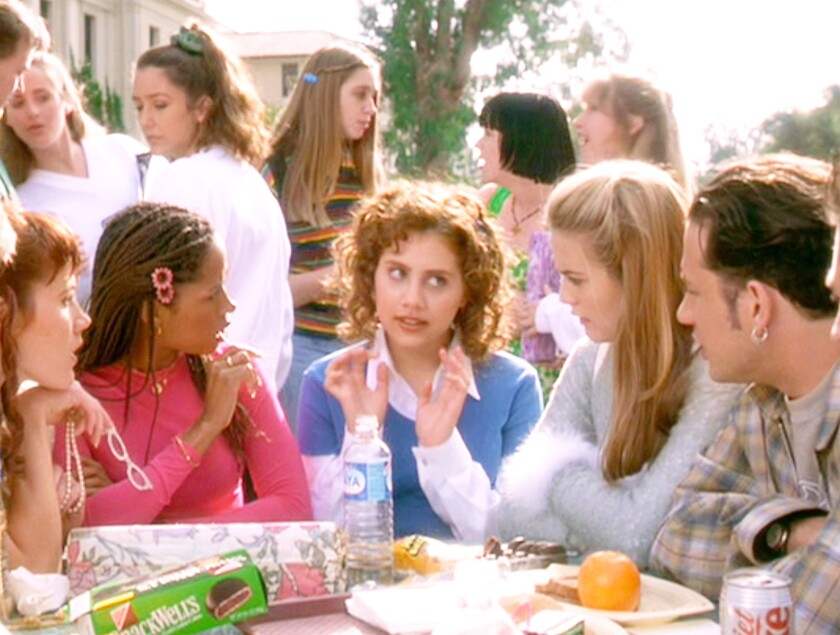 Groups of people sit around and chat during a lunch scene from "Clueless."