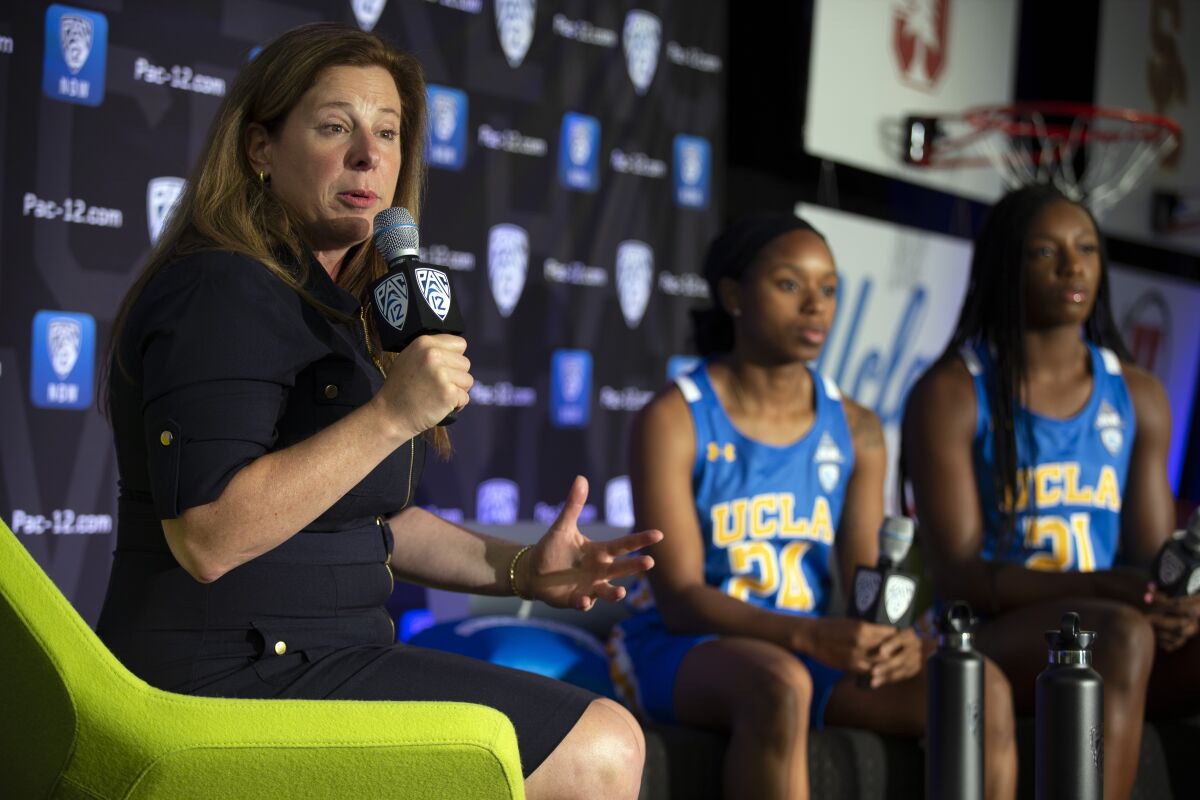 UCLA women's basketball coach Cori Close and players Japreece Dean and Michaela Onyenwere take part in Pac-12 media day 