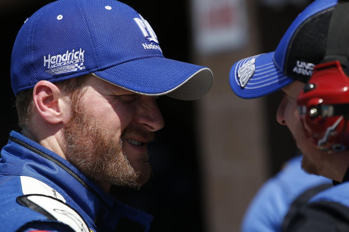 NASCAR driver Dale Earnhardt Jr. talks with his crew after a practice for the Auto Club 400 at Auto Club Speedway in Fontana on March 21.