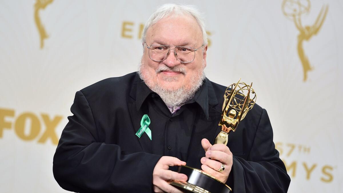 Author George R. R. Martin poses with an Emmy Award for "Game of Thrones" in 2015.
