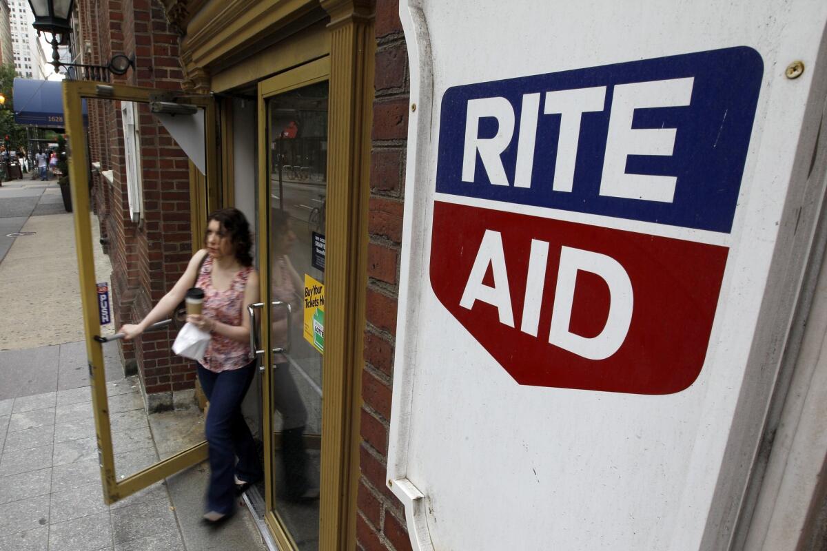 A woman exits a Rite Aid store in Philadelphia in June 2011. (AP Photo/Matt Rourke, File)