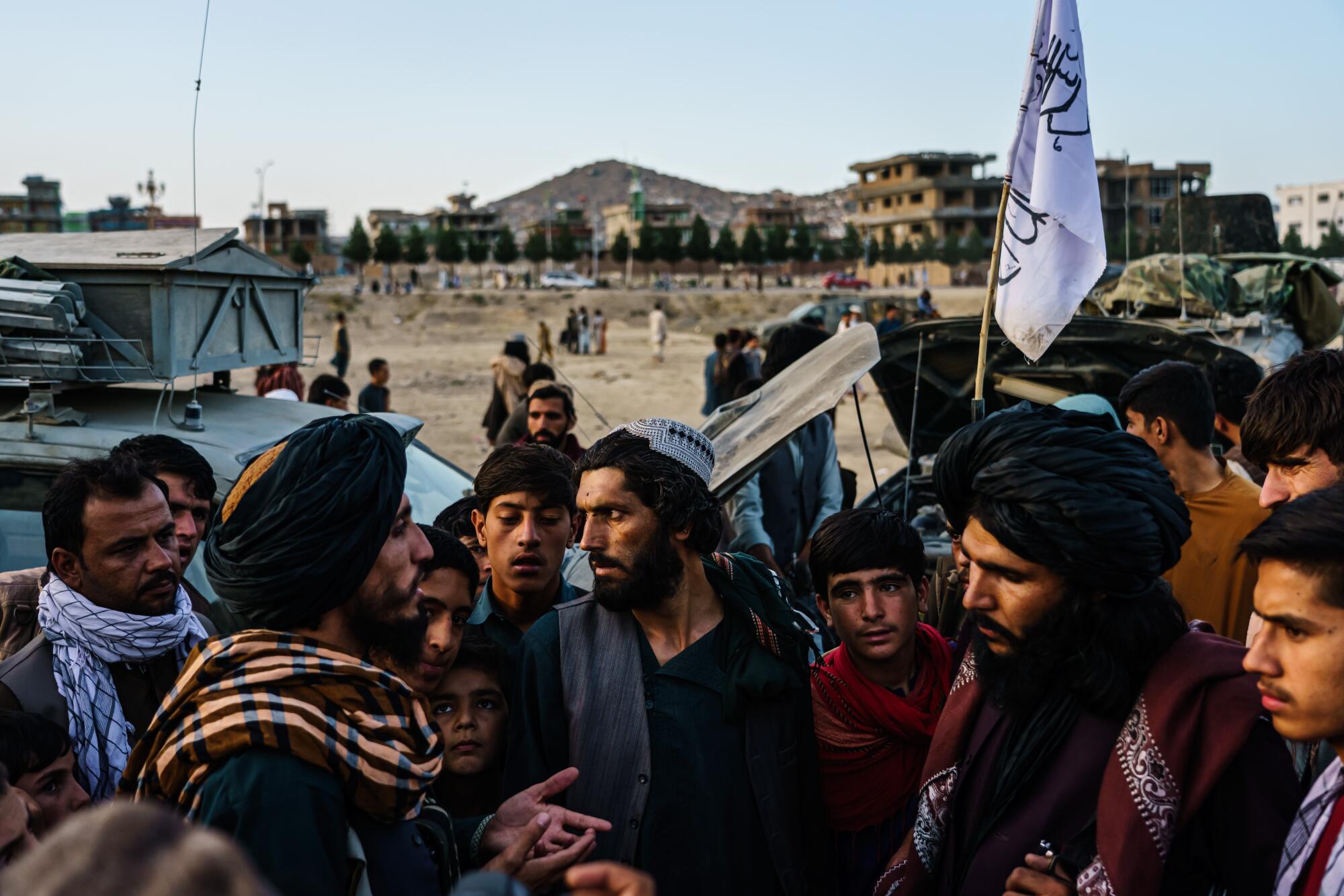Taliban fighters gather in the outskirts of Kabul