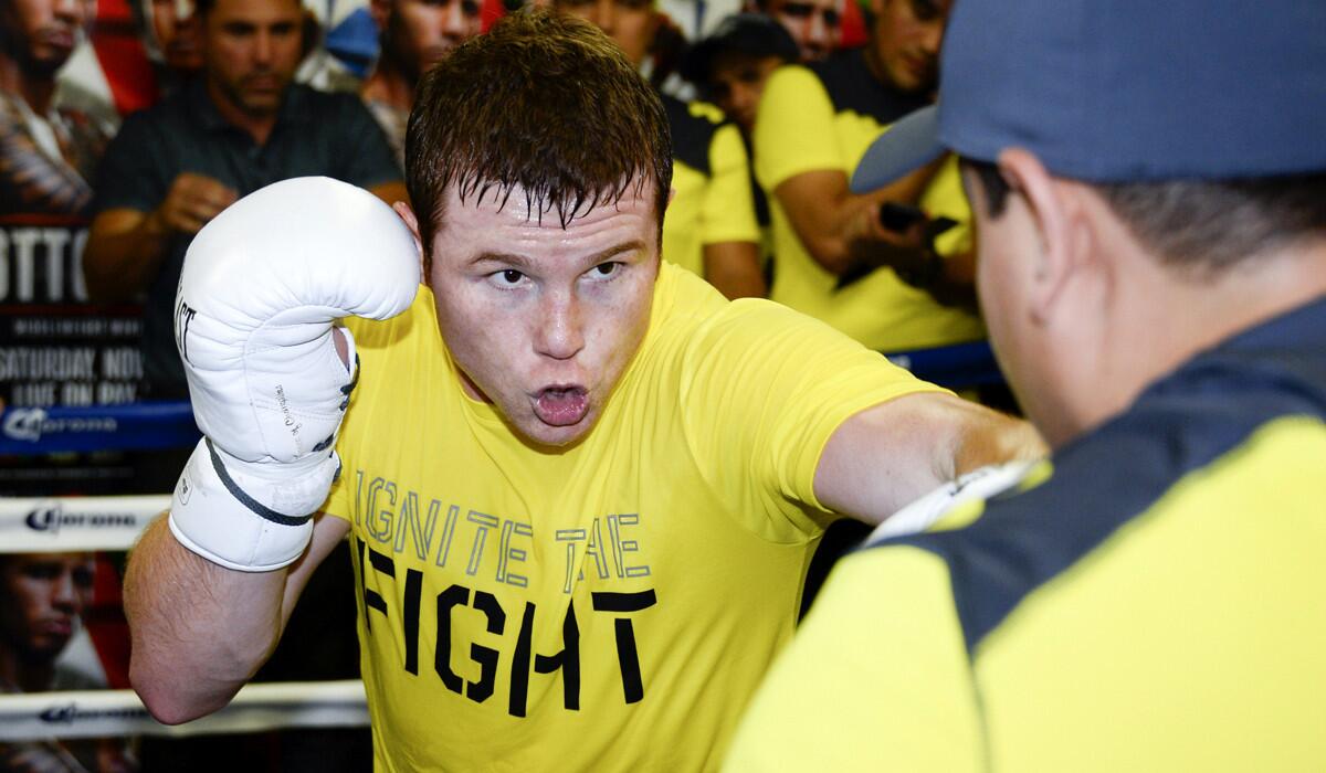 Saul "Canelo" Alvarez, left, works out in the ring with head trainer Eddy Reynoso during a media workout on Oct. 29.