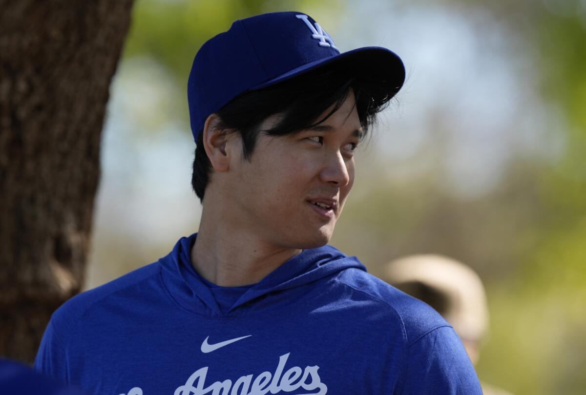 Shohei Ohtani walks back to the Dodgers clubhouse after a spring training workout.