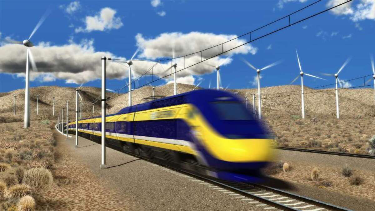 A yellow-striped blue train streaks across a desert landscape lined with wind turbines
