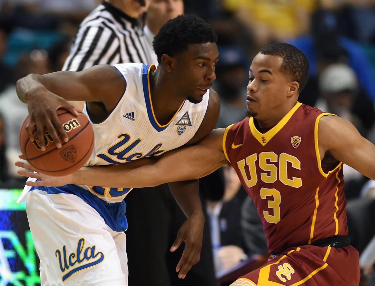 UCLA guard Isaac Hamilton is guarded by USC's Chass Bryan during a quarterfinal game of the Pac-12 Tournament on Thursday in Las Vegas.