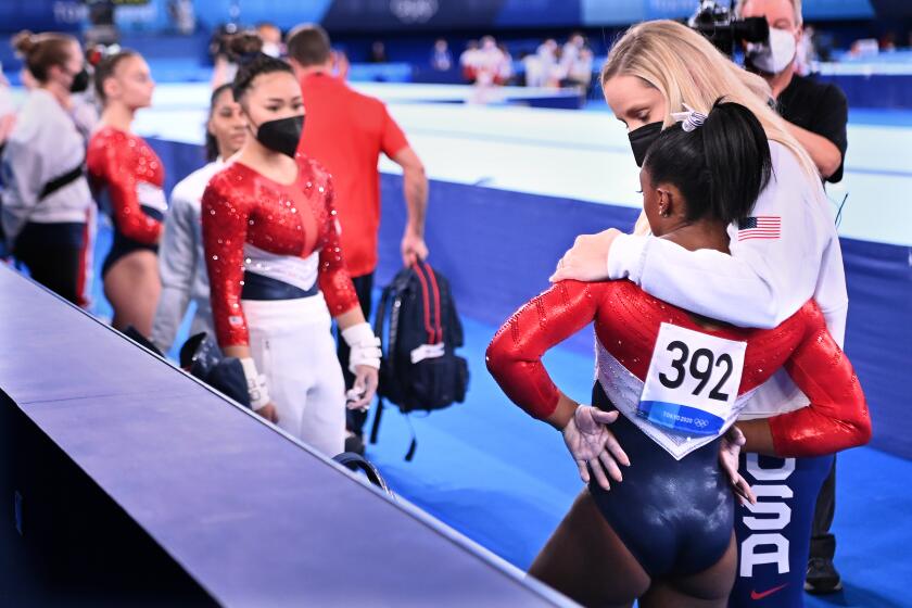 -TOKYO,JAPAN July 26, 2021: USA's Simone Biles is consoled after competing on the vault and withdrawing from competition due to an injury in the women's team final at the 2020 Tokyo Olympics. (Wally Skalij /Los Angeles Times)