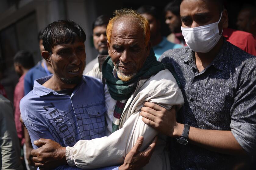 Family members of a victim of a fire that broke out overnight at a commercial complex react in a hospital in Dhaka, Bangladesh, Friday, March 1, 2024. More than forty people were killed in the fire. (AP Photo/Mahmud Hossain Opu)