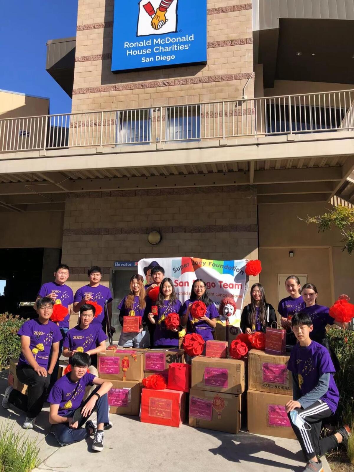Volunteers assembling presents in the garage of Ronald McDonald House.