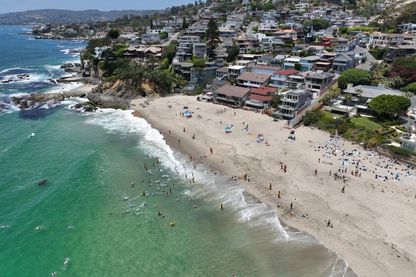 Laguna Beach, CA - June 20: Beach-goers enjoy Victoria Beach in Laguna Beach Thursday, June 20, 2024. (Allen J. Schaben / Los Angeles Times)