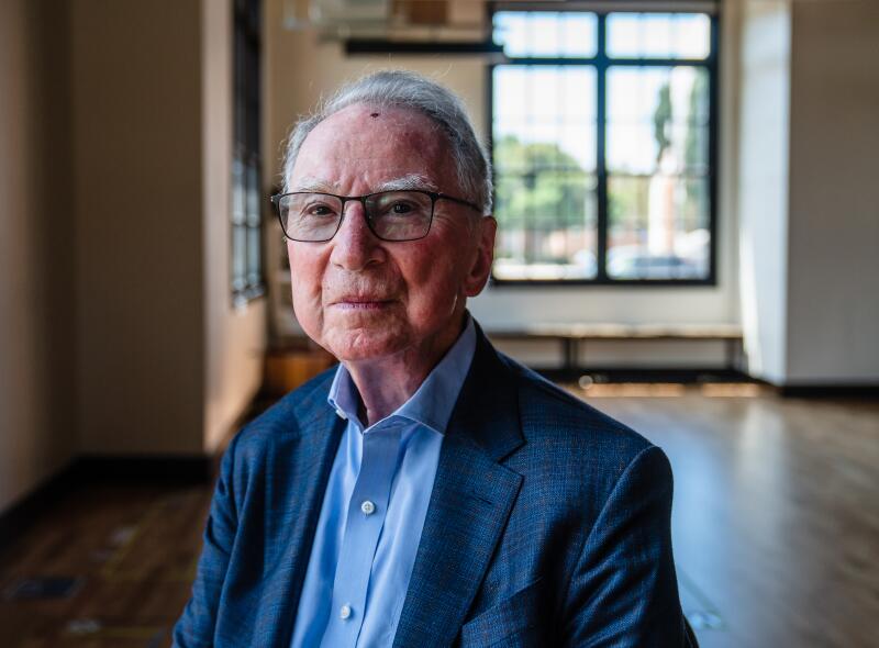 Irwin Jacobs, in a collared blue shirt and blazer, looks into the camera.