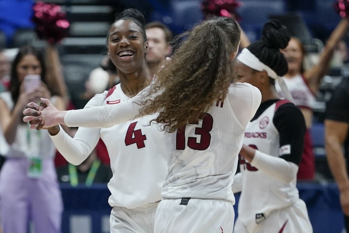 Arkansas' Erynn Barnum (4) and Sasha Goforth (13) celebrate their overtime win against Missouri in an NCAA college basketball game at the women's Southeastern Conference tournament Thursday, March 3, 2022, in Nashville, Tenn. (AP Photo/Mark Humphrey)