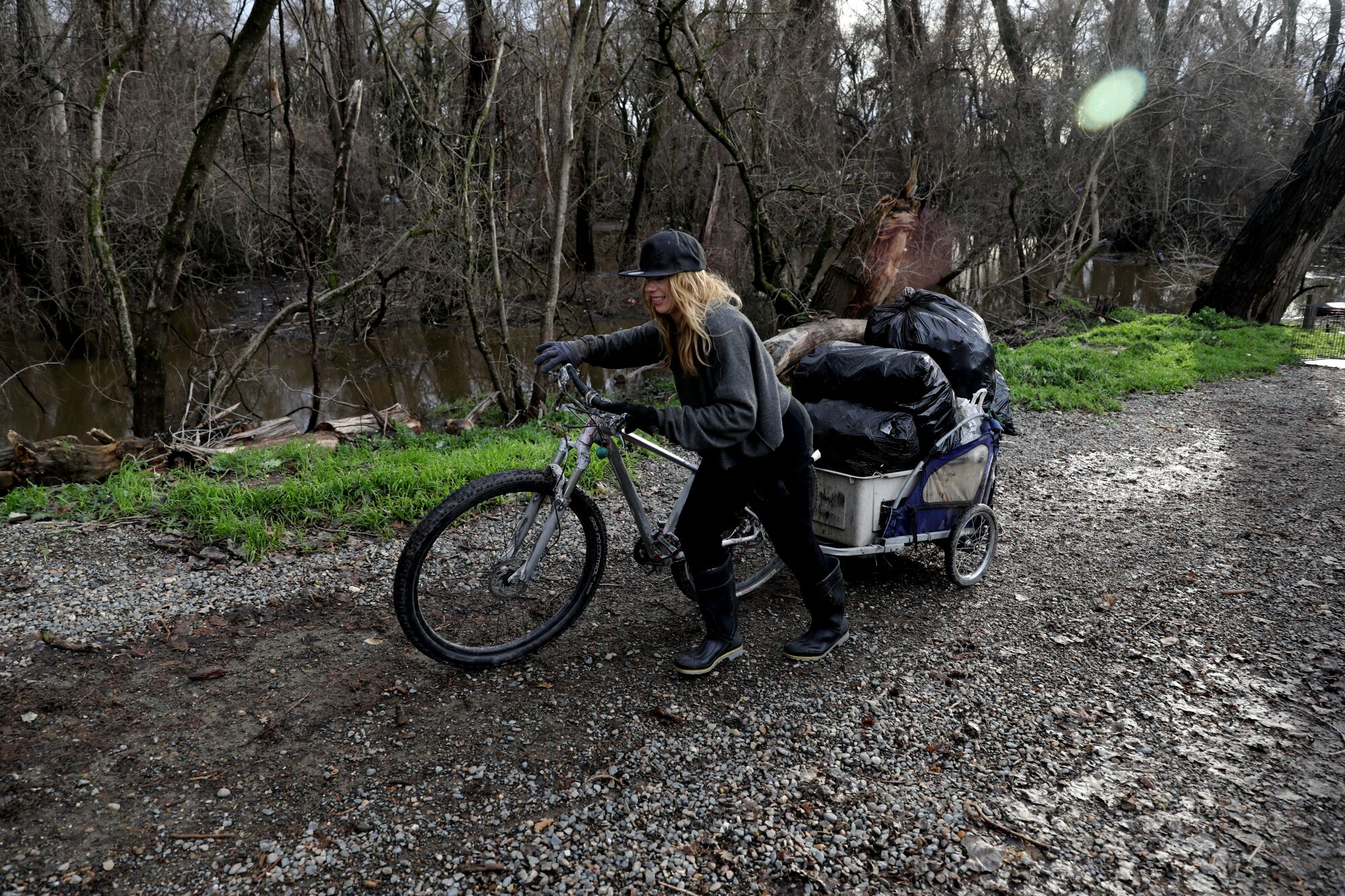 Laura Nussbaum moves her belongings to higher ground from a homeless encampment on Bannon Island.