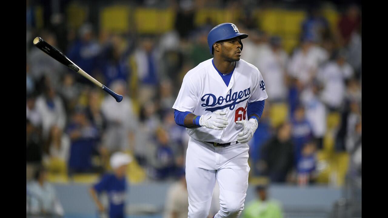 Dodgers right fielder Yasiel Puig tosses his bat after hitting a solo home run during the ninth inning of a game against the Phillies at Dodger Stadium on April 29.