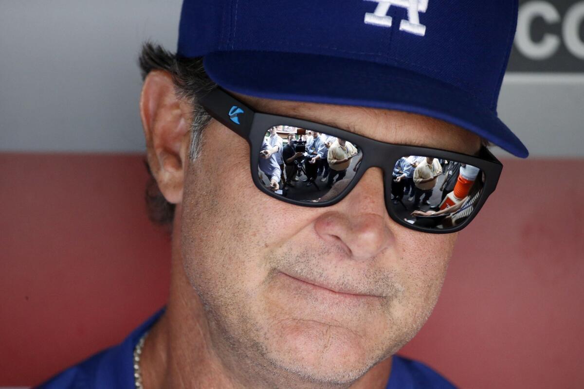 Don Mattingly speaks to reporters before the Dodgers' game against Washington at Nationals Park on July 17.