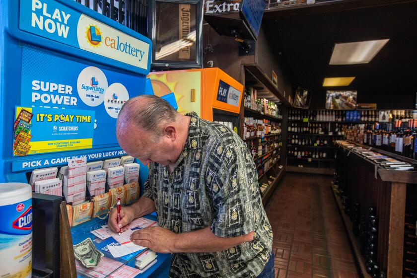 South Pasadena, CA - October 01: Lewis Hensley, 62, of Highland Park purchases a lotto ticket at Foremost Liquor Store on Sunday, Oct. 1, 2023, in South Pasadena, CA. The Powerball lottery has reached the 1 billion mark with an estimated $1.04 billion jackpot, for the next drawing on Monday night after no grand prize winner in Saturday's drawing. (Francine Orr / Los Angeles Times)