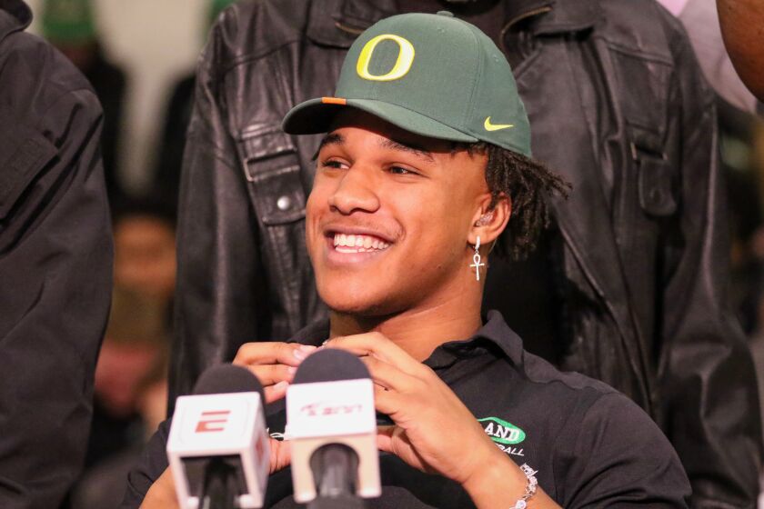 Upland linebacker Justin Flowe smiles after announcing his commitment to Oregon on Dec. 18 on the first day of the early signing period.
