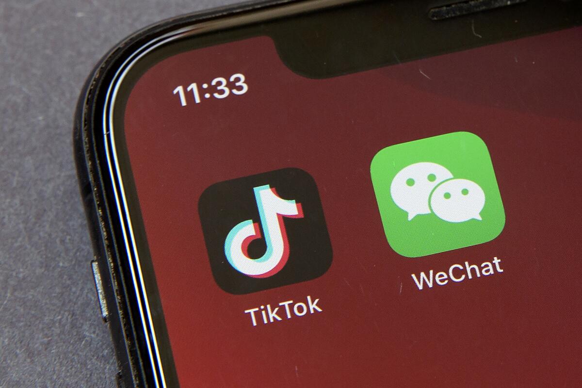 Icons for the smartphone apps TikTok and WeChat are seen on a smartphone screen.