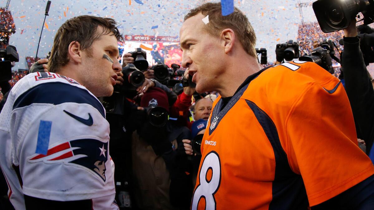 Peyton Manning, right, talks to Tom Brady after the AFC championship game on Jan. 24.