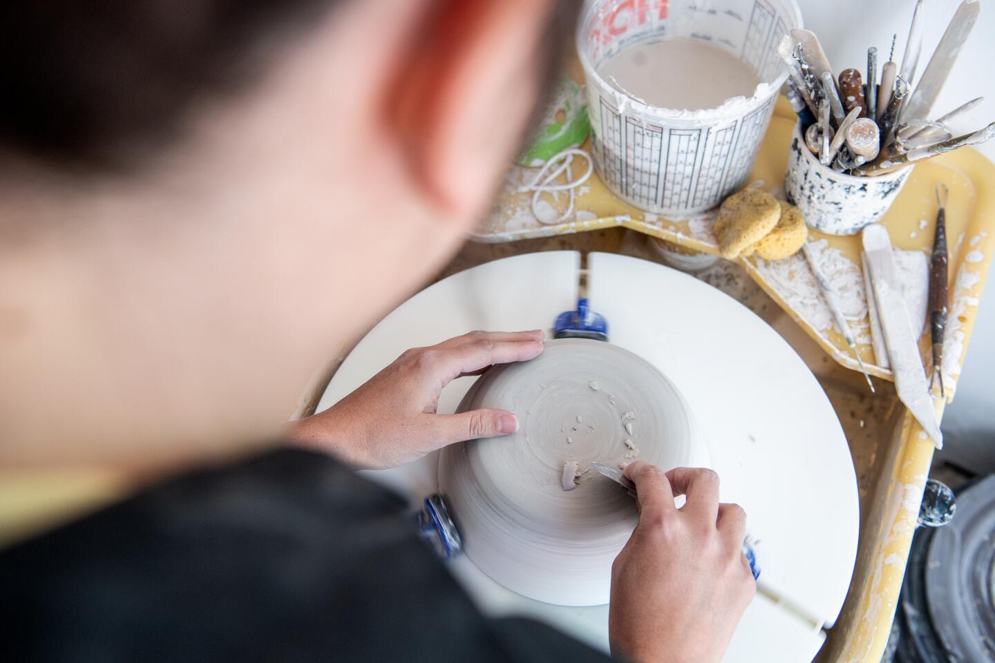 Ceramicist Brooke T. Winfrey at work inside her studio