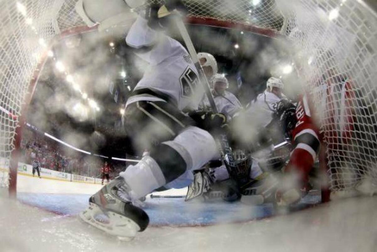 Zach Parise of the New Jersey Devils directs the puck into the net with his hand, resulting in a disallowed goal, during Game 1 of the Stanley Cup Final against the Los Angeles Kings.