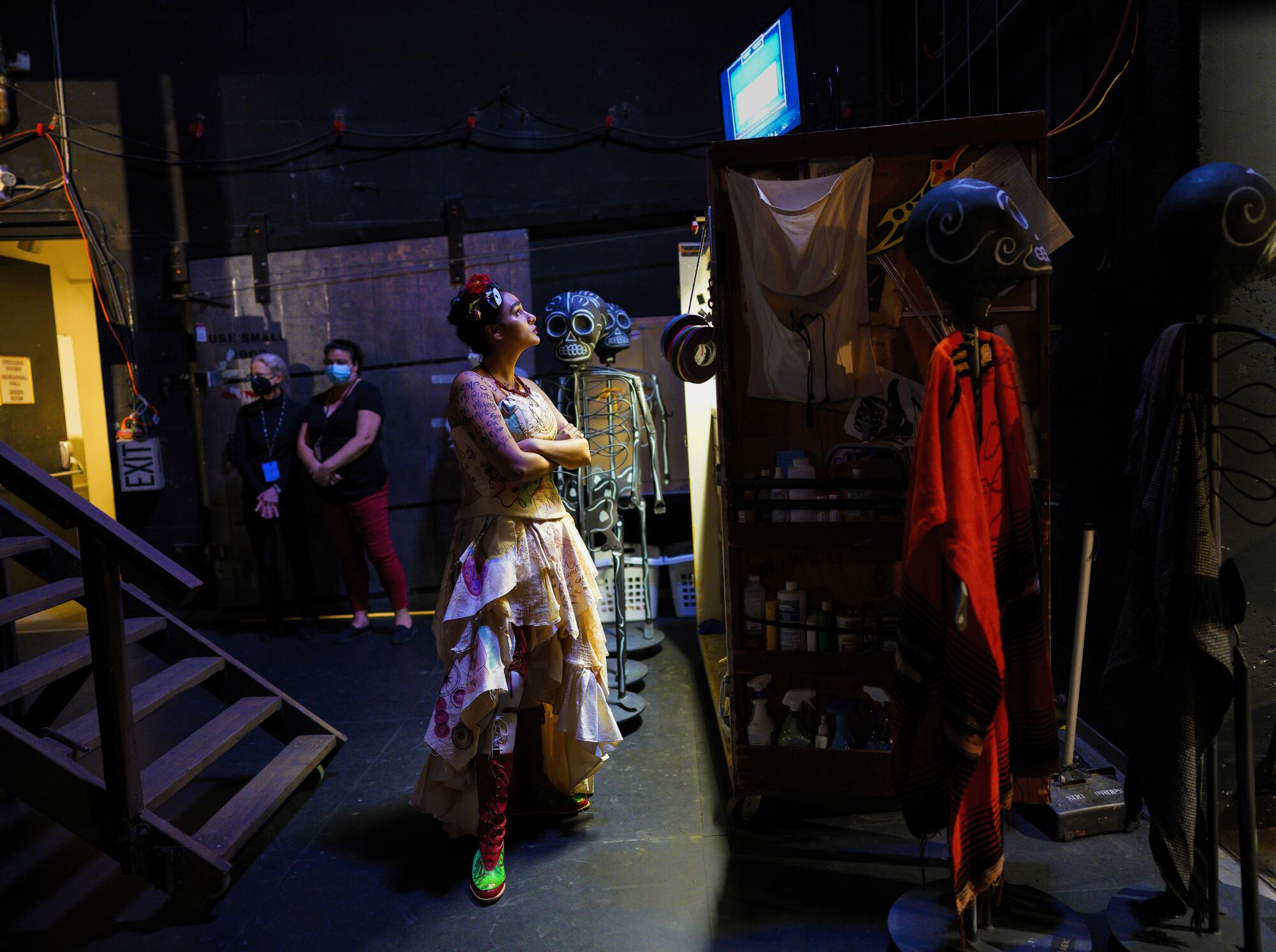 A cast member watched on the back stage monitor.