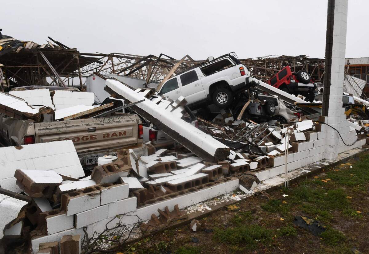 Vehicles sit beneath a destroyed building at Rockport Airport after Hurricane Harvey came ashore in south Texas.