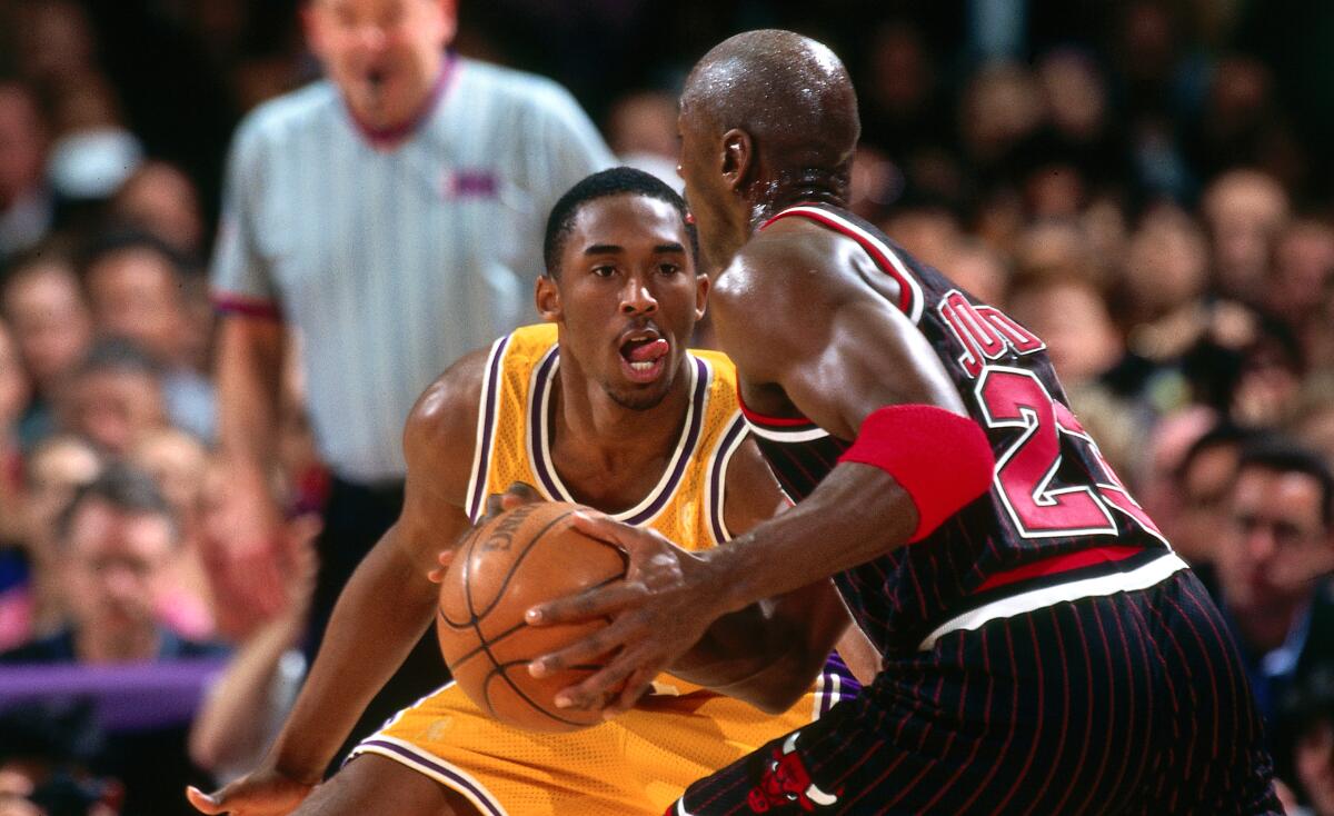 Chicago Bulls forward drives against Lakers guard Kobe Bryant during a game at the Forum in February 1997.