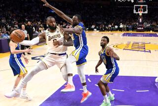 Los Angeles, California May 6, 2023-Lakers LeBron James gets a pass off in front of Warriors Draymond Green in the third quarter in Game 3 of the Western Conference semifinal at Crypto.com arena Saturday. (Wally Skalij/Los Angeles Times)