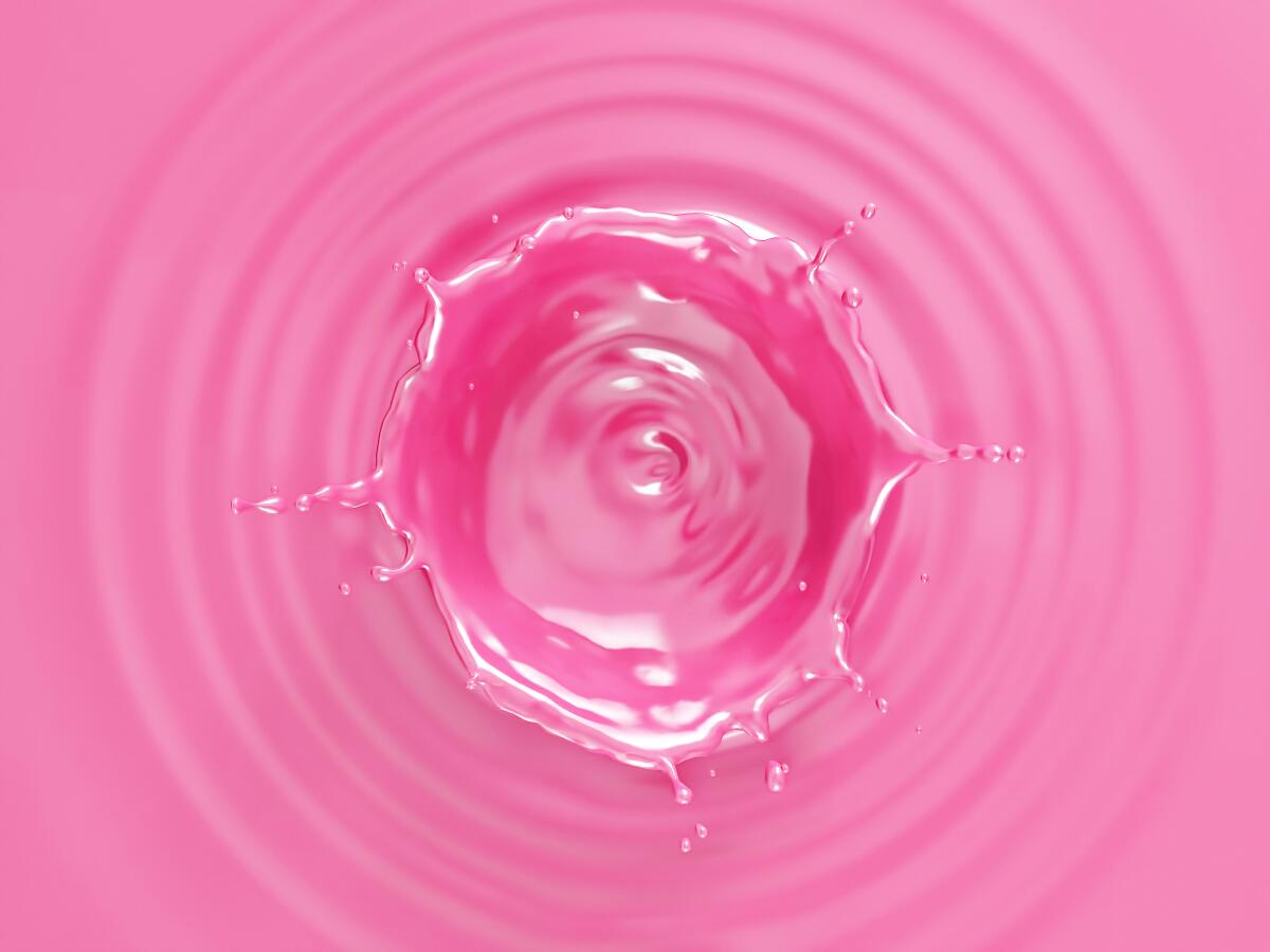 Pink liquid with ripples and crown splash viewed from above