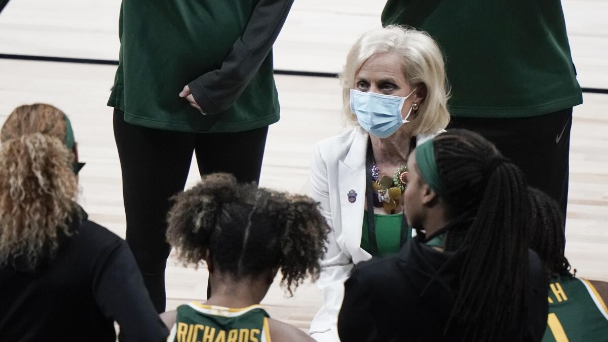 Baylor coach Kim Mulkey talks to her players in a huddle on the sideline.