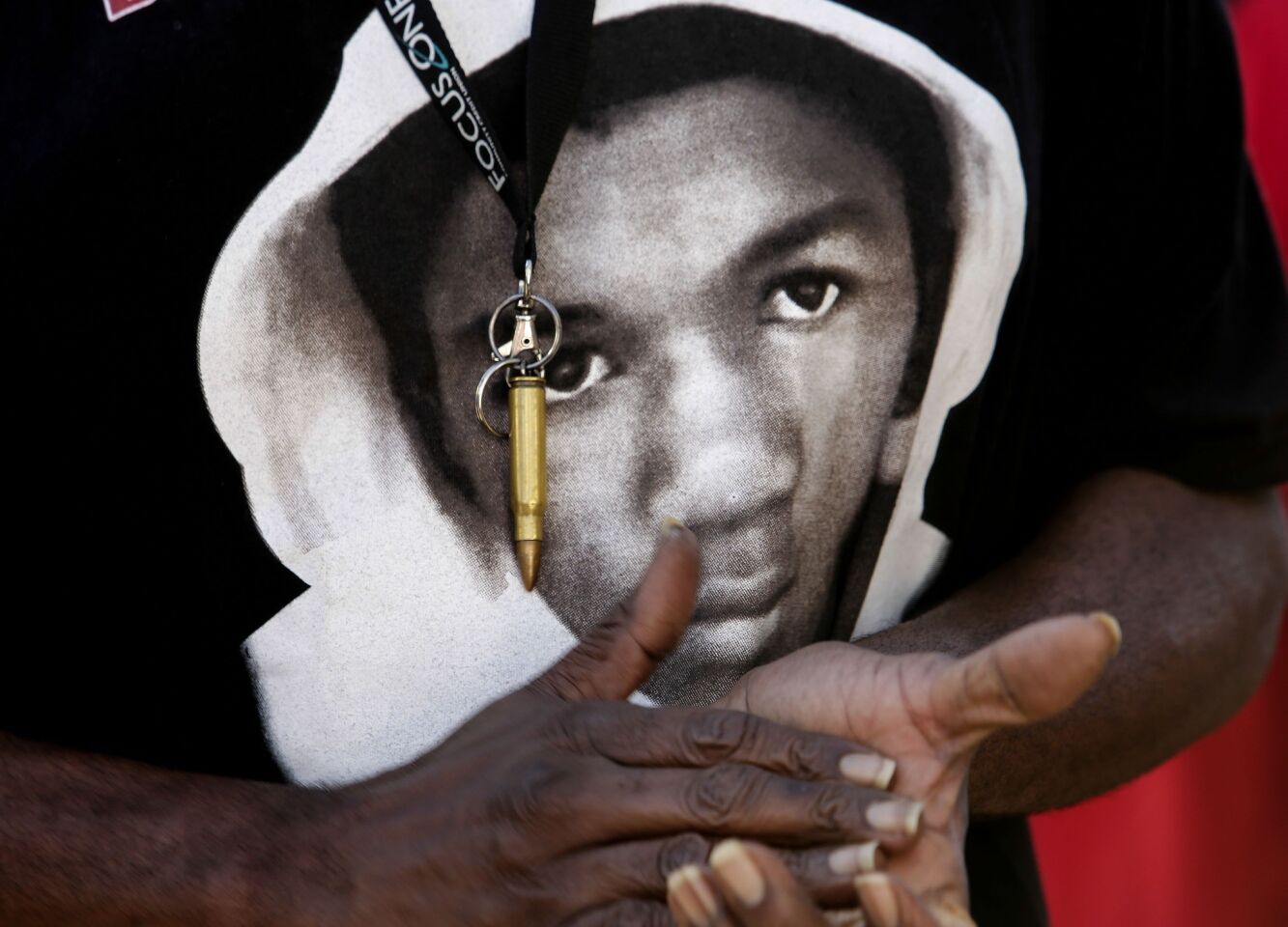 A participant in a rally Monday wears a Trayvon Martin T-shirt and a bullet pendant, in protest of the acquittal of George Zimmerman.