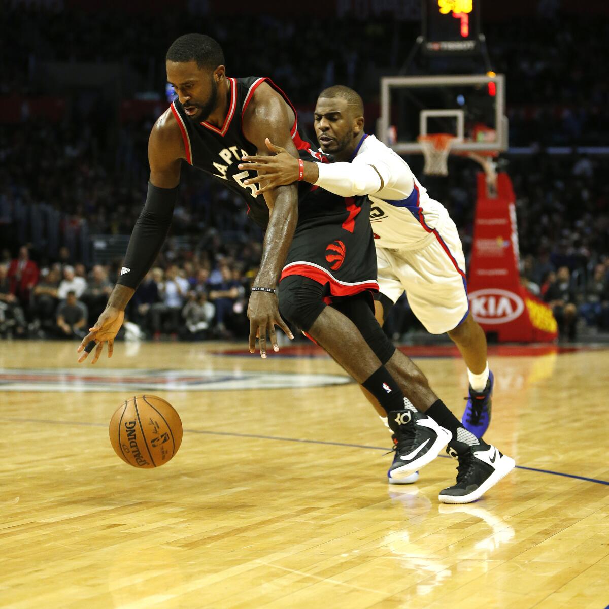 Clippers guard Chris Paul, right, goes for a steal against Raptors forward Patrick Patterson in second-half action on Nov. 21, 2016.