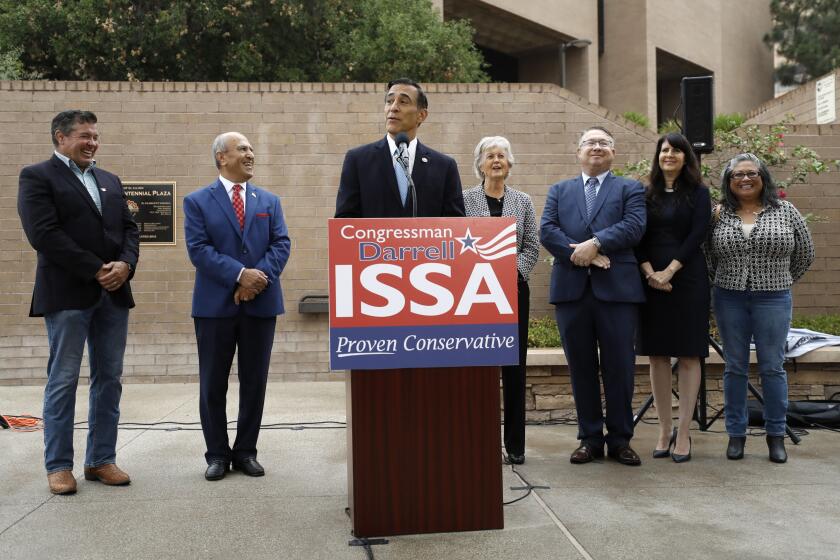Darrell Issa, center, speaks during a news conference Thursday, Sept. 26, 2019, in El Cajon, Calif. Issa, a former congressman, announced he will attempt a return to Congress to replace fellow Republican and longtime-U.S. Rep. Duncan Hunter, who is running for re-election while under indictment on corruption charges. (AP Photo/Gregory Bull)