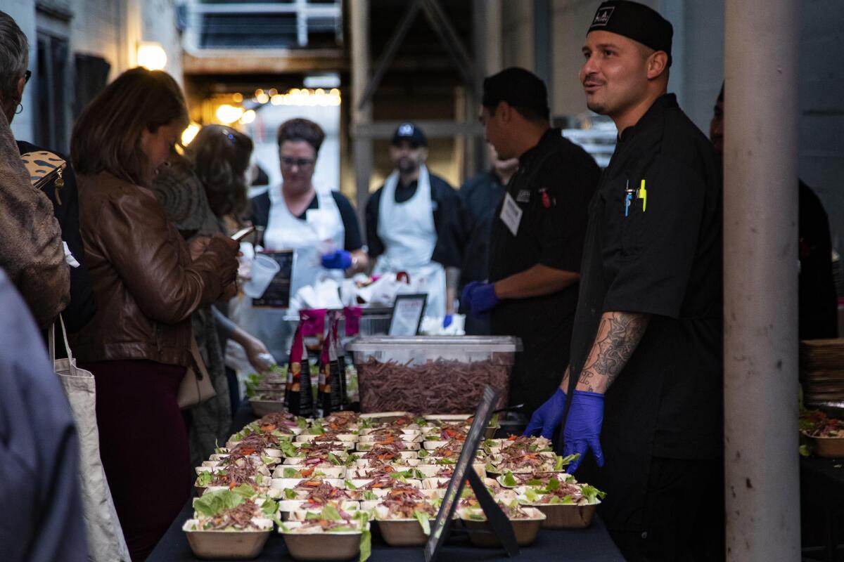 Guests arrive to try food prepared by L.A. Kitchen before Chef Jose Andres hosts a conversation on the power of food during Food Bowl.