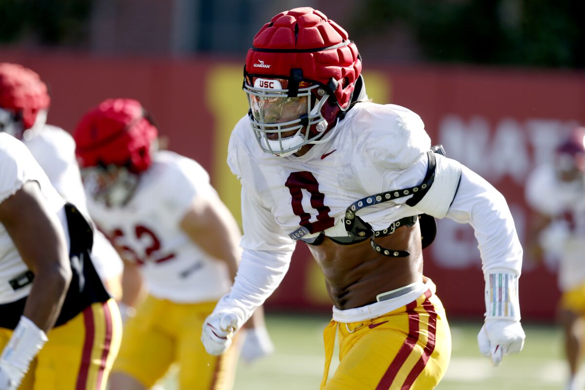 USC defensive lineman Korey Foreman lines up and runs forward during spring football practice 