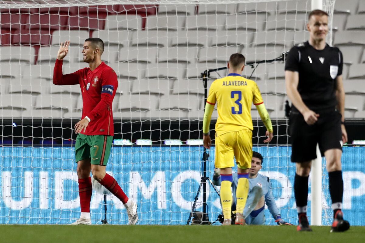 Portugal's Cristiano Ronaldo, left, reacts after scoring his teams sixth goal during the international friendly soccer match between Portugal and Andorra at the Luz stadium in Lisbon, Portugal, Wednesday, Nov. 11, 2020. (AP Photo/Armando Franca)