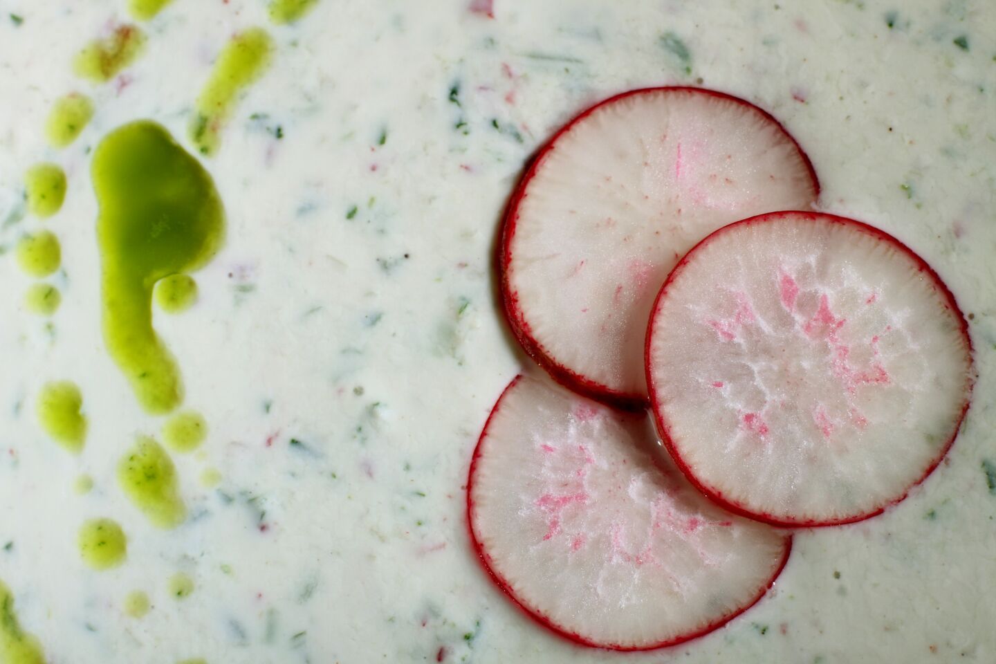 Buttermilk soup with a drizzle of green oil and radish slices hits the spot when the mercury soars.