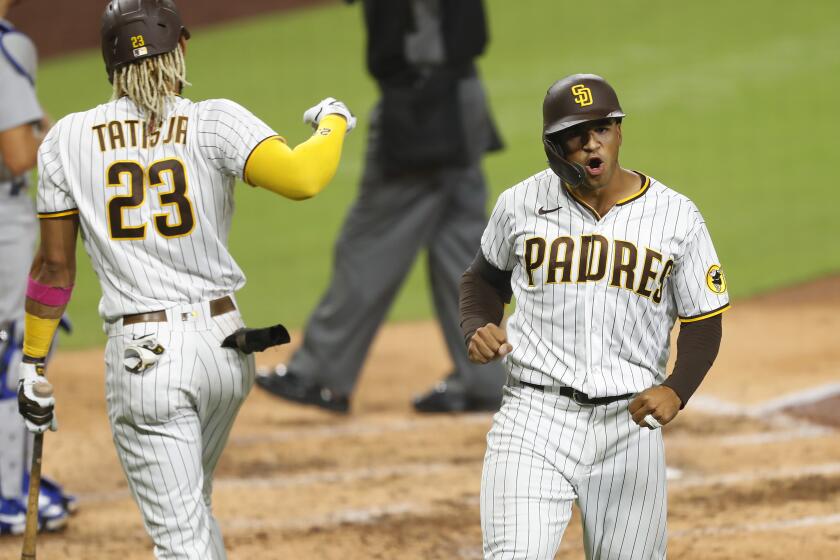 SAN DIEGO, CA - SEPTEMBER 14: Trent Grisham of the San Diego Padres celebrates with Fernando Tatis Jr. after hitting a home run in the 6th inning against the Los Angeles Dodgers at Petco Park on Monday, Sept. 14, 2020 in San Diego, CA. (K.C. Alfred / The San Diego Union-Tribune)